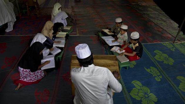 Children read from the Quran at a temporary mosque next to one damaged during riots last year on the outskirts of Kandy. Rajapaksa, often appearing alongside Buddhist monks, referred to the attacks while campaigning and cast himself as the only person able to restore security. And now nationalists like Gnanasara want him to promote Sinhalese culture at the expense of Muslims, such as getting rid of Islamic religious schools. (Dar Yasin / AP)