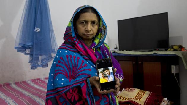 Fathima shows a photograph of her son, journalism student Abdul Bazith with a Buddhist friend, at her home on the outskirts of Kandy. Bazith died of smoke inhalation after a Buddhist monk-led mob tossed a gasoline bomb into his family home, sending it up in flames. “Sections of the Sinhala people have understood us wrongly and think that Muslims are cruel and must be eliminated,” Fazal Samsuddeen said. (Dar Yasin / AP)