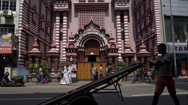 A man pushes a handcart past the Red Mosque in Colombo. Several moderate Buddhist monks in Sri Lanka have spoken out against extremist voices within their ranks, and Gnanasara and other nationalists have tried to distance themselves from the violence. Nevertheless, their influence is clear. (Dar Yasin / AP)