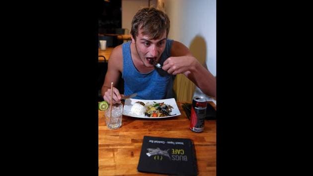Servers worked the room wearing shirts emblazoned with the words “I HATE INSECTS”, with the “H” crossed out. British backpacker Joshua Bean, 23, said he knew he had to visit the cafe after seeing an ad for the unusual eatery at his hostel. (Tang Chhin Sothy / AFP) Servers worked the room wearing shirts emblazoned with the words “I HATE INSECTS”, with the “H” crossed out. British backpacker Joshua Bean, 23, said he knew he had to visit the cafe after seeing an ad for the unusual eatery at his hostel. (Tang Chhin Sothy / AFP)