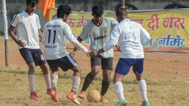 Players of Valley Hunters football club (white) in action against Strikers FC team at Guru Tegh Bahadur football tournament at COEP ground in Pune on Thursday. (MILIND SAURKAR/HT) Players of Valley Hunters football club (white) in action against Strikers FC team at Guru Tegh Bahadur football tournament at COEP ground in Pune on Thursday. (MILIND SAURKAR/HT)