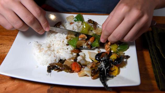 Bean didn’t flinch at the “juicy” silkworms and an assortment of other insects piled up on his plate. “It’s not the kind of thing you get back home,” he said. (Tang Chhin Sothy / AFP) Bean didn’t flinch at the “juicy” silkworms and an assortment of other insects piled up on his plate. “It’s not the kind of thing you get back home,” he said. (Tang Chhin Sothy / AFP)