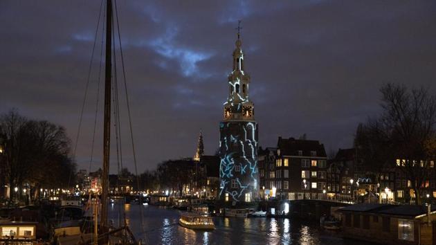 A light art work titled “The Cracks” by Karolina Howorko is projected on Montelbaan’s tower during the Amsterdam Light Festival in Amsterdam, Netherlands. The theme of the open air exhibition is “DISRUPT!”, and the art works are exhibited from November 28 to January 19, 2020. (Peter Dejong / AP)