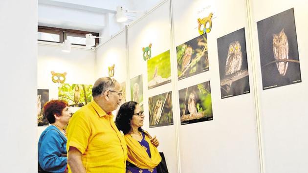 People admire photographs of owls during an exhibition organised by Ela Foundation, during the 6th World Owl Conference, at Savitribai Phule Pune University, on Friday. The exhibition is open till December 2.(Milind Saurkar/HT Photo)