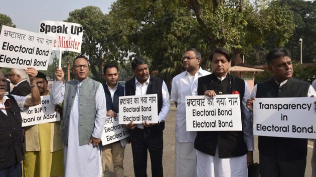 MPs from Congress protest against the lack of transparency in electoral bonds, in front of the Gandhi Statue at the Parliament during the Winter Session in New Delhi.(Vipin Kumar/HT PHOTO)