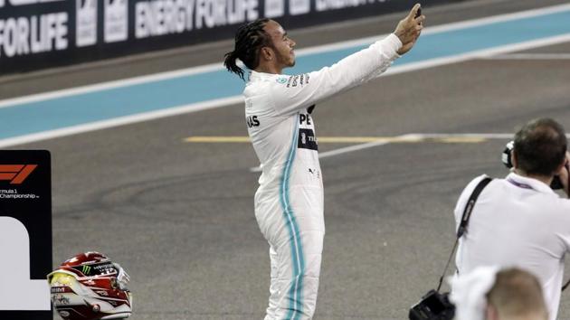 Mercedes driver Lewis Hamilton of Britain uses his mobile phone. (AP) Mercedes driver Lewis Hamilton of Britain uses his mobile phone. (AP)