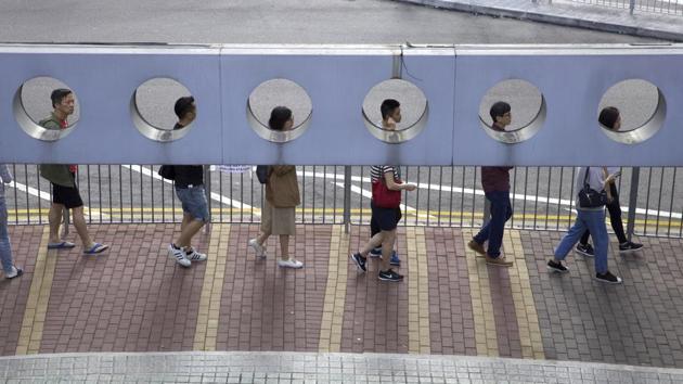 People line up to vote outside of a polling place in Hong Kong, on November 24. Long lines formed outside Hong Kong polling stations Sunday in elections that have become a barometer of public support for anti-government protests now in their sixth month. (Ng Han Guan / AP)