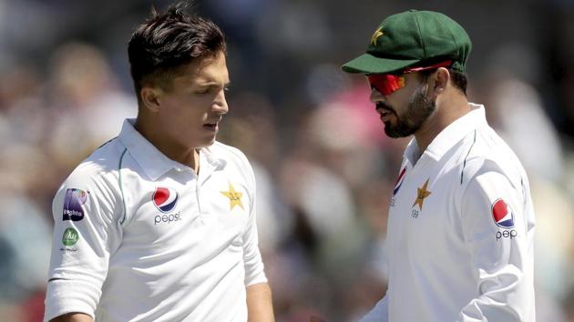 Pakistan's Musa Khan, left, talks to Azhar Ali during their during their cricket test match against Australia in Adelaide.(AP)