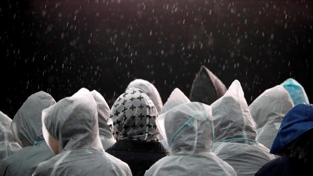 Well-wishers wait in the rain ahead of Pope Francis’ arrival for a tribute to the Martyr Saints at the Martyrs’ Monument at Nishizaka Hill, in Nagasaki, Japan. (Kim Hong-Ji / REUTERS)