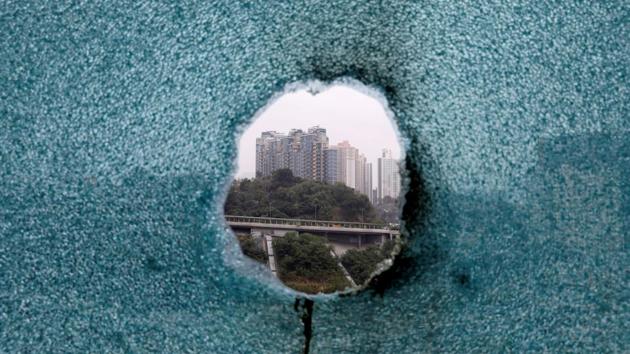 A shattered window is seen during a search operation at Hong Kong Polytechnic University, in Hong Kong, China. (Adnan Abidi / REUTERS)