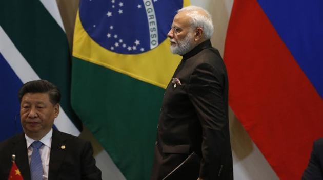 India's Prime Minister Narendra Modi walks past China's President Xi Jinping at the Leaders Dialogue with BRICS Business Council and the New Development Bank at the Itamaraty Palace in Brasilia, Brazil on November 14, 2019.(AP)