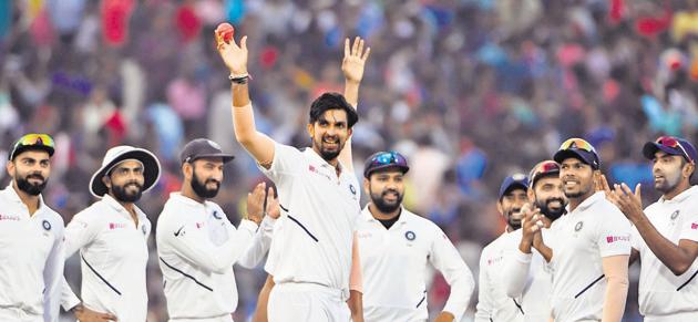 Ishant Sharma (C) shows the pink ball as he celebrates his five-wicket haul with teammates during the first of the second Test match, which is the first-ever pink ball day-night Test match between India and Bangladesh at Eden Gardens in Kolkata on November 22.(AFP FILE/PHOTO)