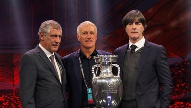 Portugal coach Fernando Santos, France coach Didier Deschamps and Germany coach Joachim Loew pose with the trophy after being drawn in group F(REUTERS)