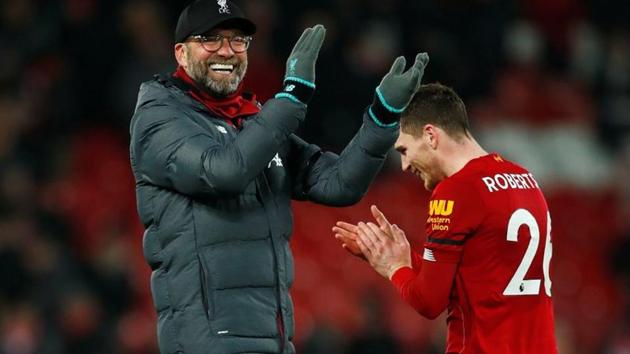 Liverpool manager Juergen Klopp and Andrew Robertson celebrate after the match(REUTERS)