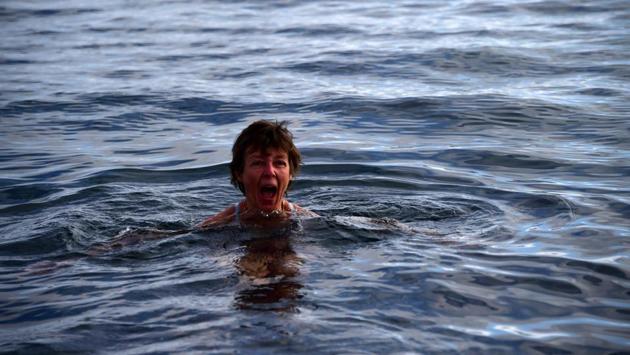 A tourist swims on Half Moon island. “The continent probably would be better off being left to penguins and researchers, but the reality is, that is probably never going to happen,” said Michael Hall, professor and expert on polar regions at the University of Canterbury in New Zealand. (Johan Ordonez / AFP) A tourist swims on Half Moon island. “The continent probably would be better off being left to penguins and researchers, but the reality is, that is probably never going to happen,” said Michael Hall, professor and expert on polar regions at the University of Canterbury in New Zealand. (Johan Ordonez / AFP)