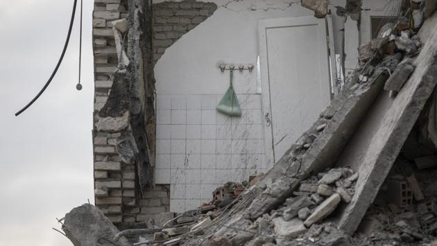 A plastic bag with washing powder hangs on a wall of a collapsed building in Thumane. The worst hit areas were the port town of Durres, a popular beach vacation spot for Albanians that is 33 kilometers west of the capital Tirana, and the nearby town of Thumane. (Petros Giannakouris / AP)