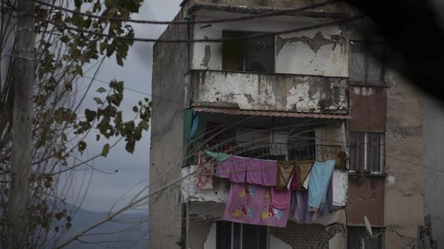 Laundry hangs on a line from a damaged building in Thumane. Both locations saw apartment buildings crumble from the power of the earthquake. Hundreds of rescuers from more than a dozen countries from Europe and beyond flew in to help in search-and-rescue operations, while more countries sent in medical supplies, tents and other forms of aid. (Petros Giannakouris / AP)