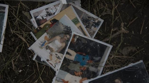 Family pictures are seen on the ground of a damaged building in Thumane. The prime minister said preliminary figures showed more than 1,465 buildings in the capital, Tirana, and about 900 in Durres were seriously damaged in Tuesday’s 6.4-magnitude pre-dawn quake. (Petros Giannakouris / AP)