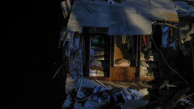 A cupboard stands in a collapsed building in Thumane. A new draft law will sentence all investors, architects and supervisors to seven to 15 years in prison for violating construction norms. That and corruption in Albania’s burgeoning building industry have been blamed for much of the quake’s effects. (Petros Giannakouris / AP)
