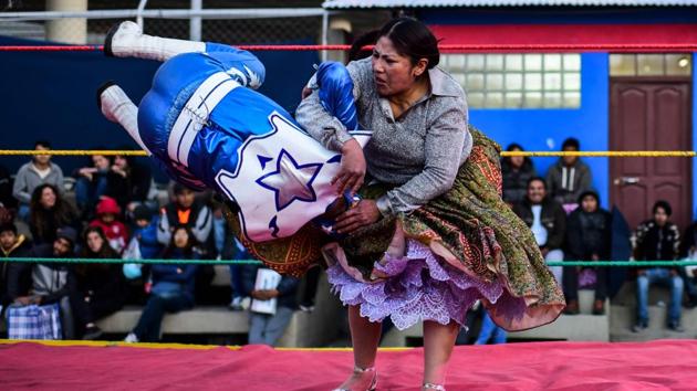 Luisa Yujra (R), fights with a male wrestler. Weeks of unrest triggered by the disputed October 20 election, which Evo Morales claimed to have won and opposition groups said was rigged, have made life difficult and dangerous for people in El Alto, a stronghold for Morales. With roads blocked and many afraid to leave their homes in the city, the Sunday high-altitude wrestling matches were cancelled for a fortnight. (Ronaldo Schemidt / AFP)