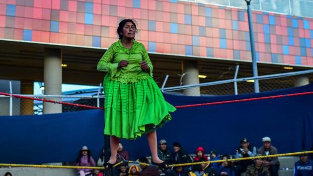 Lidia Flores, performs at Sharks of the Ring wrestling club. Flores said wrestling is a welcome relief from the pressure of her day job cooking in a restaurant. “Wrestling de-stresses me,” Flores, 44, told AFP as she stoods outside the venue before the match handing out fliers to people walking through a street market. After a fortnight hiatus, the feisty mother of three, who has been wrestling for 12 years, was “very keen” to get back in the ring. (Ronaldo Schemidt / AFP)