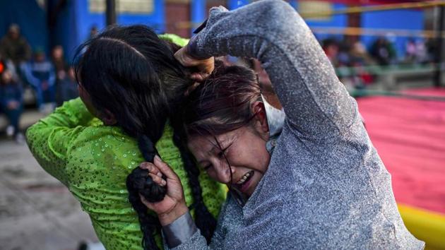Ana Luisa Yujra (R) and Lidia Flores fight. “It was the first time (in eight years) that we had to stop because of conflict,” said organizer Marie Penaranda, 30, as she sold tickets for 20 bolivianos (around $3) each. Tensions eased at the weekend with the passing of a bill authorizing new elections and ongoing talks between the caretaker government and protesters aimed at ending the unrest. (Ronaldo Schemidt / AFP)