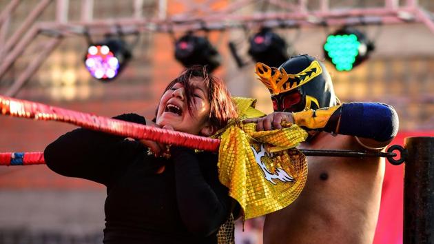 Blanca Perez (L), aka “Katy The Beautiful”, fights with a male wrestler. Ana Luisa Yujra said the spectacle is “affordable” therapy for the crowd after so much violence. “I love demonstrating the ability, agility and capacity that a woman can have,” said Yujra, who works as a geriatric nurse. “It is really admirable ... how these women in a pollera can get into the ring, wrestle, be in those positions,” Martha Mayta, a spectator told AFP. (Ronaldo Schemidt / AFP)