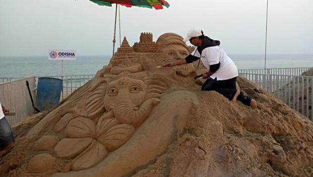 A sand artist gives finishing touch during the celebration on the occasion of International Sand Art Festival, at Chandrabhaga beach in Konark on Sunday. 123 artists from across India & artists from USA, Ireland, Denmark, Russia, Canada, Togo & Sri Lanka are participating in Sand Art Festival.