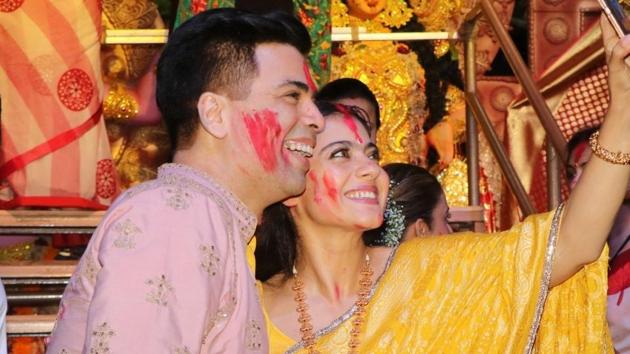 Filmmaker Karan Johar and actress Kajol pose for selfies during Vijaya Dashami celebrations.(IANS)