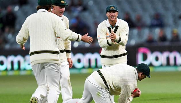 Australia's Steve Smith (bottom) takes a catch to dismiss Pakistan batsman Azhar Ali(AFP)