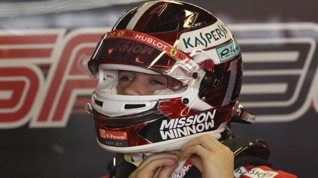 Charles Leclerc of Monaco puts on his helmet during the first free practice at the Yas Marina racetrack in Abu Dhabi.(AP)