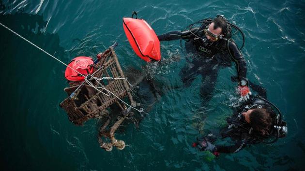 Volunteer divers retrieve rusted shopping carts from the sea in the port of the Ionian island of Zakynthos. Dressed in her protective wetsuit and scuba gear, Antigone Kouteri jumped into the murky waters of Zakynthos harbour in search of plastics -- and promptly snagged her arm on a submerged object. “It was a tyre,” offered her patrol mate Efthymis, coming up with a discarded beer bottle. “My treat!” he jibed. (Louisa Gouliamaki / AFP)