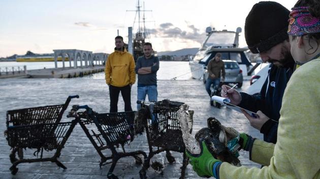 Volunteers register the type of waste retrieved from the sea, during a cleaning operation. The HCMR has also helped develop a floating litter-collection barrier that is currently deployed at the mouth of Kifissos river in Athens. “I believe everybody should change habits. We don’t have to use plastics in our everyday life,” said George Triantaphyllidis. (Louisa Gouliamaki / AFP)