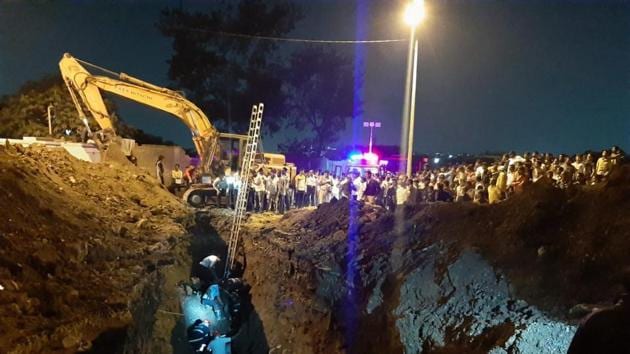 Rescue personnel come to aid after three firefighters trying to rescue a boy who fell into a trench Pimpri Chinchwad area got trapped after it caved in, in Pune. (PTI) Rescue personnel come to aid after three firefighters trying to rescue a boy who fell into a trench Pimpri Chinchwad area got trapped after it caved in, in Pune. (PTI)