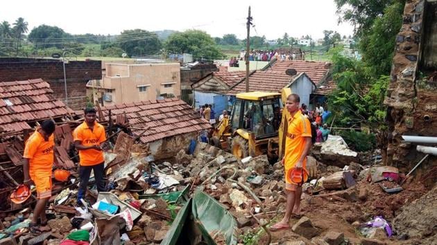 Rescue workers clear debris from a collapsed home in Mettupalayam, some 50 kilometers north of Coimbatore, on Monday. At least 17 people from four families were buried alive as they were sleeping when heavy rains caused a large wall to collapse on their homes, police said. ((ANI Photo)) Rescue workers clear debris from a collapsed home in Mettupalayam, some 50 kilometers north of Coimbatore, on Monday. At least 17 people from four families were buried alive as they were sleeping when heavy rains caused a large wall to collapse on their homes, police said. ((ANI Photo))