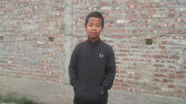 Isaac standing in front of his village school in Manipur’s Churachandpur district. (HT) Isaac standing in front of his village school in Manipur’s Churachandpur district. (HT)