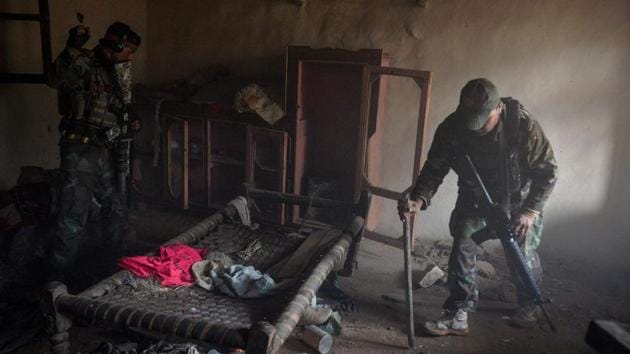 Afghan security forces clear houses during an operation. Is-K confounded early US predictions they would be defeated quickly, withstanding continual air strikes, as well as battles with the rival Taliban. They replenished their ranks using a mix of cash and extreme ideology spread inside Kabul’s universities. (Noorullah Shirzada / AFP)