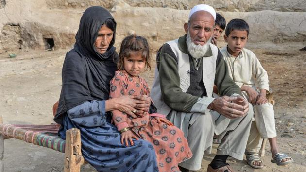 Gulnar Malik and her family sit outside their house's premises in Achin district. “They shot dead one of my children and injured another. My dead boy was trying to run away when they shot him,” she recalled, adding that her husband had been detained and tortured over a three-week period. Malik went home last month having spent years in the comparative safety of a nearby town. (Noorullah Shirzada / AFP)