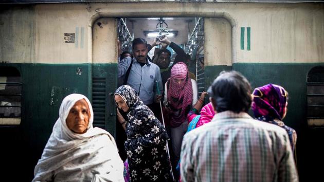 Sharma (back, C) prepares to exit a train upon arriving at Okhla railway station on his way to the Blind Relief Association in New Delhi. On trains, where passengers are packed like sardines in the megacity of 20 million people, he is dependent on fellow commuters helping him to navigate platforms and squeeze in and out of carriages. (Xavier Galiana / AFP)
