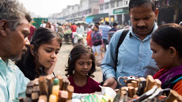 Vinod Kumar Sharma (2nd R) checks a padlock as his wife Indrapti (R) and daughters watch during grocery shopping at Oklha wholesale vegetable market. Swapna Merlin from the Blind Relief Association said many of its trainees are from rural regions and have been brought up to believe that they could not exist outside their families’ care. (Xavier Galiana / AFP)