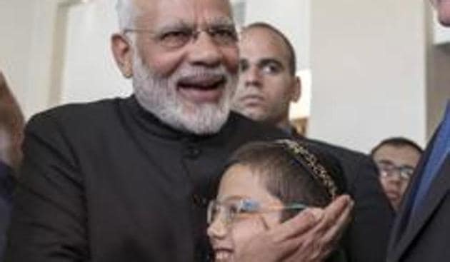 Prime Minister Narendra Modi with Moshe Holtzberg, center, an Israeli boy, whose parents were killed in the November 26, 2008 terrorist attack on the Mumbai Chabad House, in Jerusalem, July 5, 2017. (AP) Prime Minister Narendra Modi with Moshe Holtzberg, center, an Israeli boy, whose parents were killed in the November 26, 2008 terrorist attack on the Mumbai Chabad House, in Jerusalem, July 5, 2017. (AP)