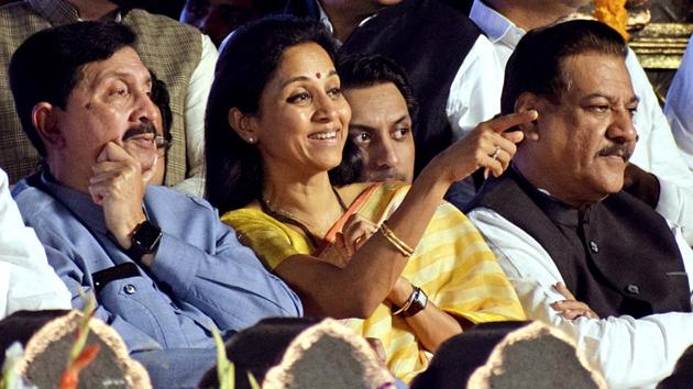 NCP leader Supriya Sule with Senior Congress leader Ashok Chavan (R) during the swearing-in ceremony of Chief Minister of Maharashtra Uddhav Thackeray at Shivaji Park in Mumbai.