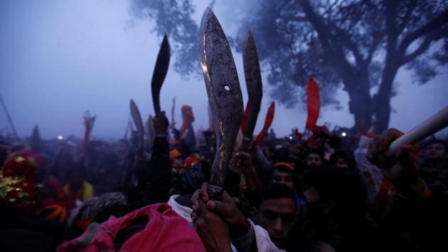 Devotees raise their sacrificial blades as the sacrificial ceremony of the “Gadhimai Mela” festival begins at Bariyarpur, Nepal. The five-yearly festival, believed to be the world’s biggest animal sacrifice at one place, began on Tuesday in the presence of a huge number of pilgrims from India, amid protests by animal activists. Though the month-long festival started on November 17, the main sacrifice days were on December 3 and 4. (Navesh Chitrakar / REUTERS)