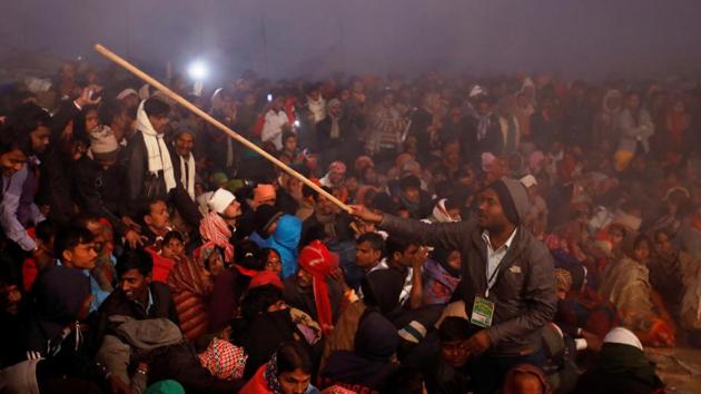 A volunteer controls a crowd using a stick during the ritual. Indian border authorities and volunteers have in recent days seized scores of animals being brought across the frontier by unlicensed traders and pilgrims. While this has failed to stop the flow, officials and animal rights groups say such efforts combined with awareness campaigns have helped decrease the bloodshed. (Navesh Chitrakar / REUTERS)