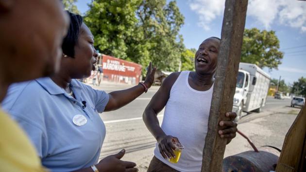 Jerlene Layne (L), talks with Damian Brown while patrolling. “We used to make good money. If they could just come in with the marker a little more, we can dive behind the marker — it could work,” Brown said, noting that the buoys’ current placement mean the water is too deep to dive in without a tank. “If I back down on this, what kind of message does that send?” she said. “You have to stand for something.” (David Goldman / AP)