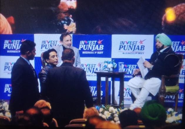 A youngster being led away after he disrupted chief minister Capt Amarinder Singh’s interaction with TV host Prannoy Roy that was being telecast live on the inaugural day of the Progressive Punjab Investors Summit in Mohali on Thursday.(HT Photo)