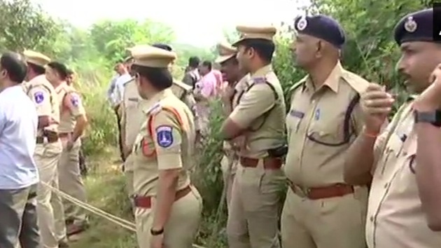 Police officers at the site where the four accused in rape and murder of a veterrinary doctor in Telangana were killed in encounter on Dec 6, 2019. (ANI / Twitter) Police officers at the site where the four accused in rape and murder of a veterrinary doctor in Telangana were killed in encounter on Dec 6, 2019. (ANI / Twitter)