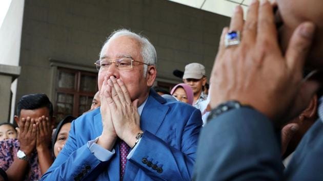 Former Malaysian Prime Minister Najib Razak prays with his supporters before entering a court room at Kuala Lumpur High Court in Kuala Lumpur, Malaysia. The former Malaysian prime minister was a “victim” of the multi-million dollar 1MDB scandal that saw state coffers drained on his watch, his lawyer said, as the ex-premier gave evidence in his own fraud trial. (Lim Huey Teng / REUTERS)