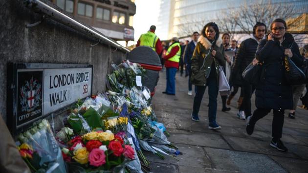 Floral tributes are left for Jack Merritt and Saskia Jones, who were killed in a terror attack in London, England. A former prisoner convicted of terrorism offences, killed two people in Fishmongers’ Hall at the North end of London Bridge on November 29, before continuing his attack on the bridge. The man was restrained and disarmed by members of the public before being shot by armed police. (Peter Summers / Getty Images)