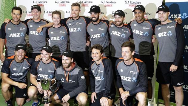 New Zealand players pose with the trophy after the second cricket test between England and New Zealand at Seddon Park.(AP)